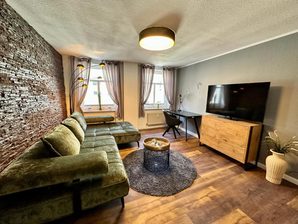 a living room with a couch and a flat screen tv at Stilvoll Wohnen in Schwerin