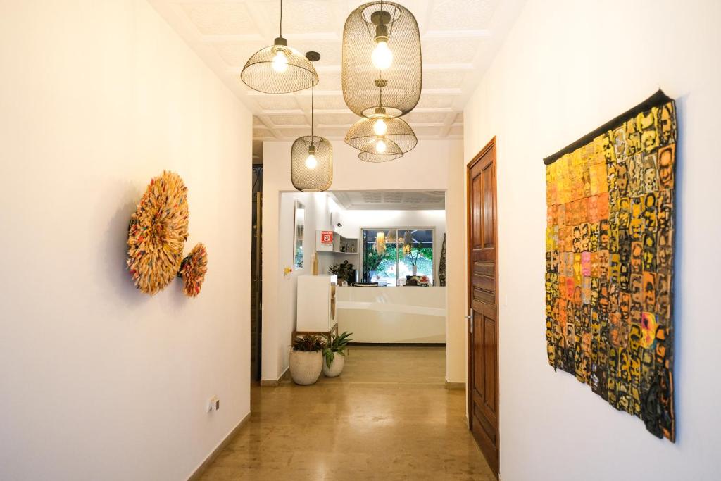 a hallway with a large painting on the wall at Villa Ayaba in Abidjan