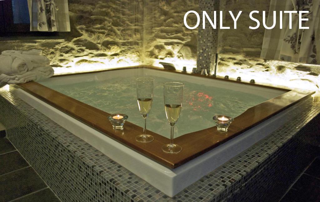 a bathtub with two glasses of champagne in it at Casa La Rosa in Coreglia Ligure