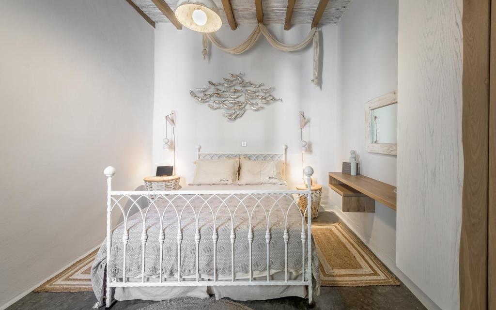 a white bedroom with a bed in a room at villa lord in Pollonia