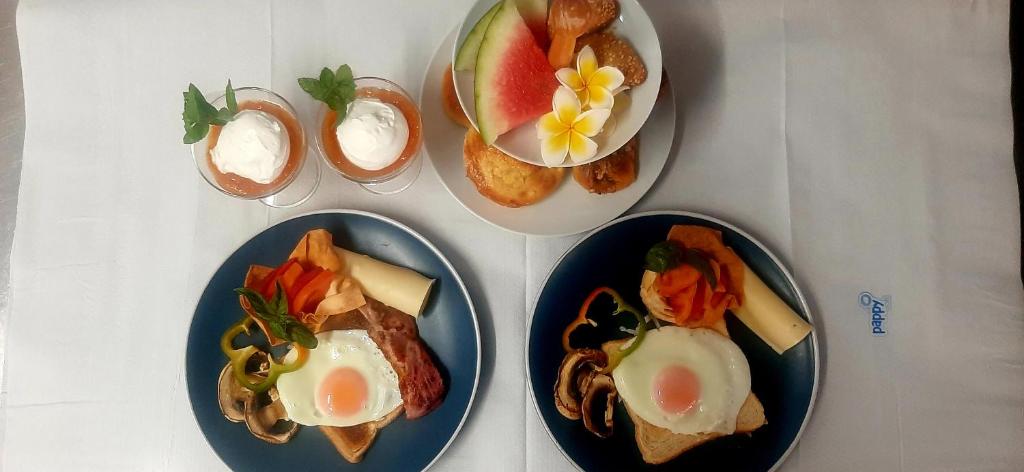 three plates of food on a table with eggs at Agia Roumeli Hotel in Agia Roumeli