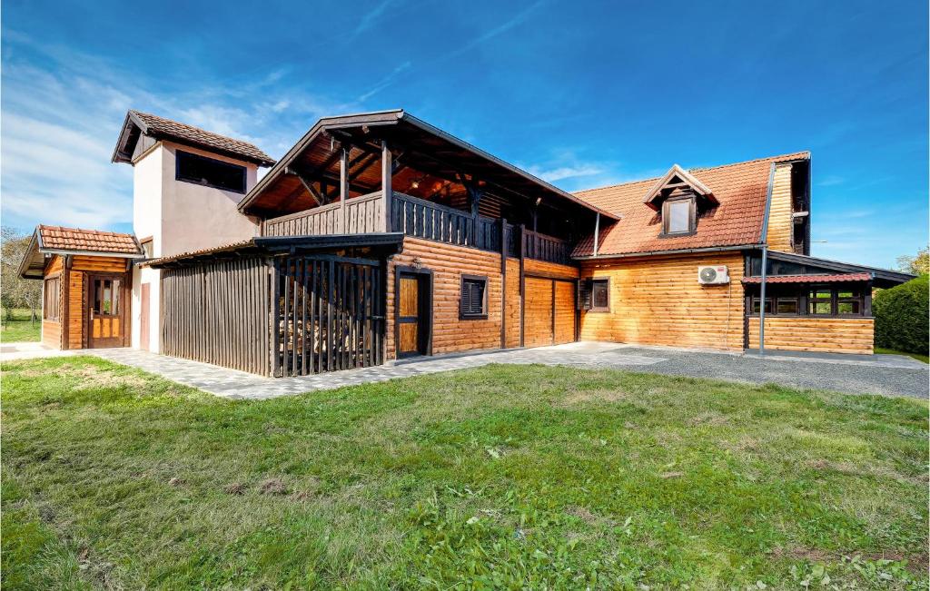 a large wooden house with a large yard at 3 Bedroom Lovely Home In Gornji Cerovljani 