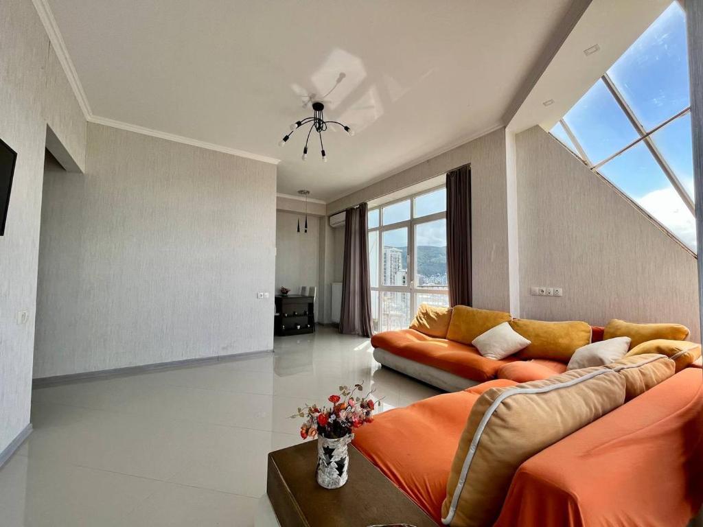 a living room with a couch and a large window at Graz Narek house in Altenfelden