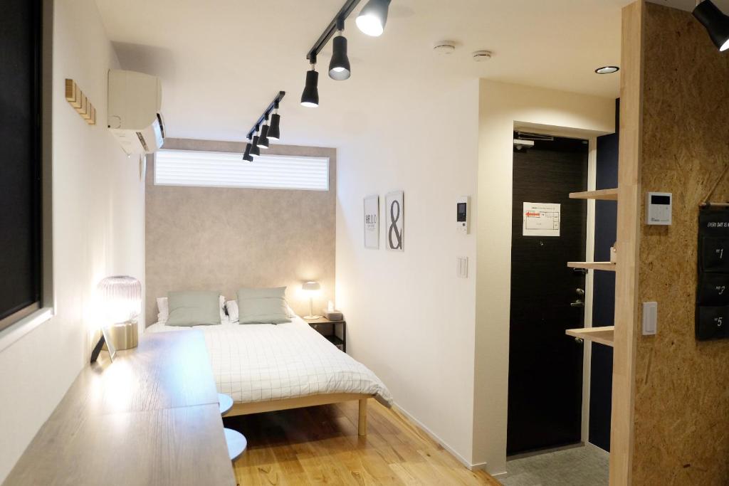 a bedroom with a bed and a large window at 夢の舎 Asakusa Horizon Bleu in Tokyo