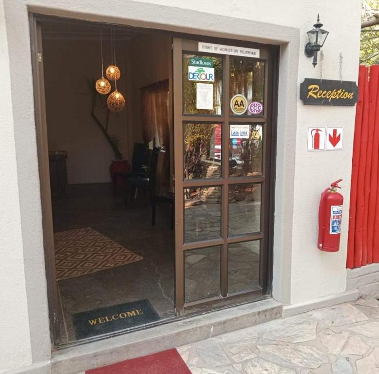 an entrance to a restaurant with a revolving door at Faith City Guesthouse in Outjo