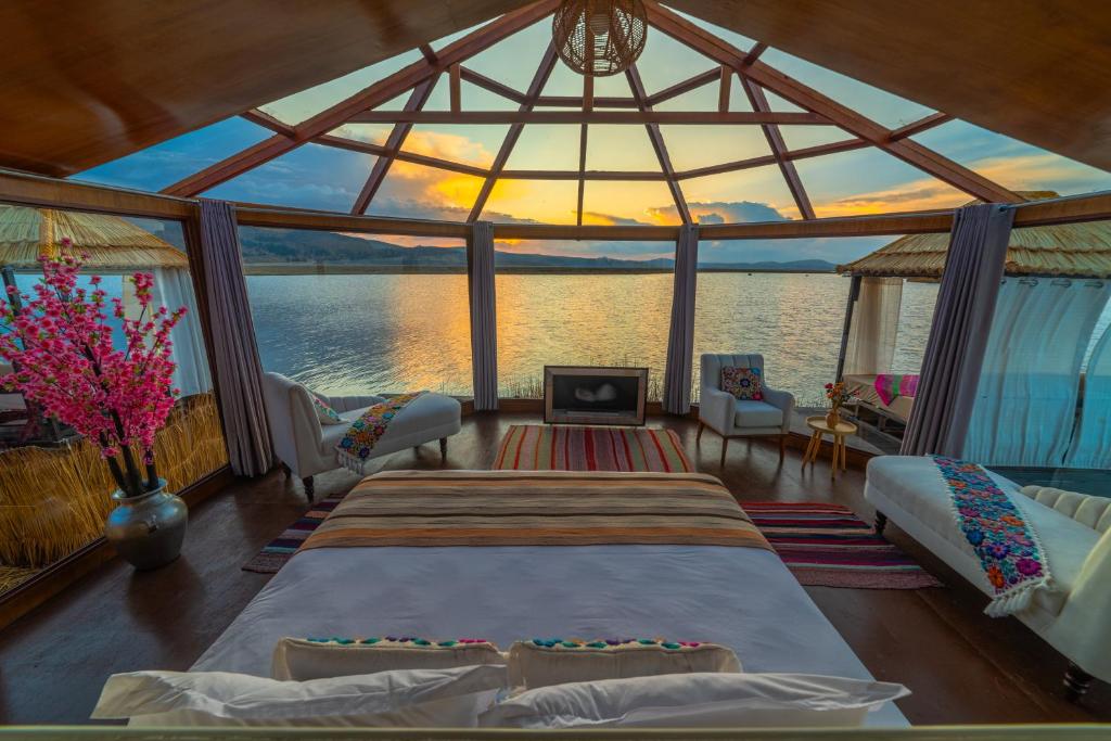 a bedroom on a boat with a view of the water at KAY PACHA LODGE lago titicaca All Inclusive in Puno