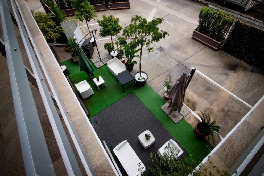 an overhead view of a patio with chairs and plants at COMÓ EXCLUSIVE in Aprilia