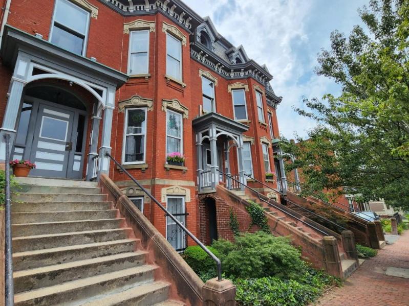 a red brick house with stairs in front of it at MOMA Your Historic Stay in Springfield