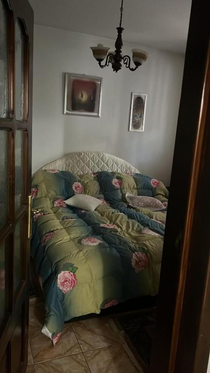 a bed with pillows on it in a room at Elegant Boem Apartment in Focşani