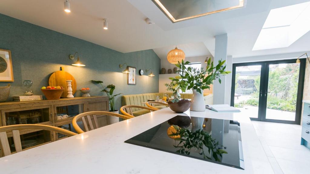 cocina y comedor con mesa y sillas en The Papered House, en Beaumaris
