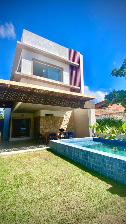 a house with a swimming pool in front of it at Casa Garaguá - Porto de Pedras,AL - Patacho in Pôrto de Pedras