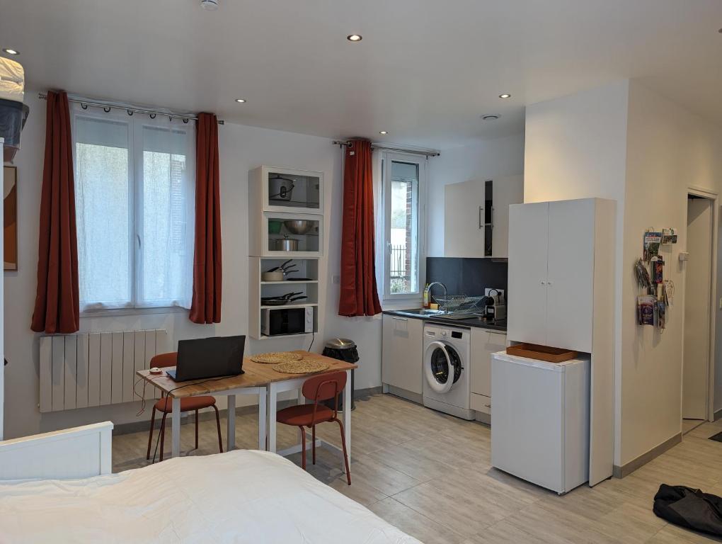 a kitchen with a table with a laptop on it at Studio Vue Loir, Centre-Ville in Bonneval