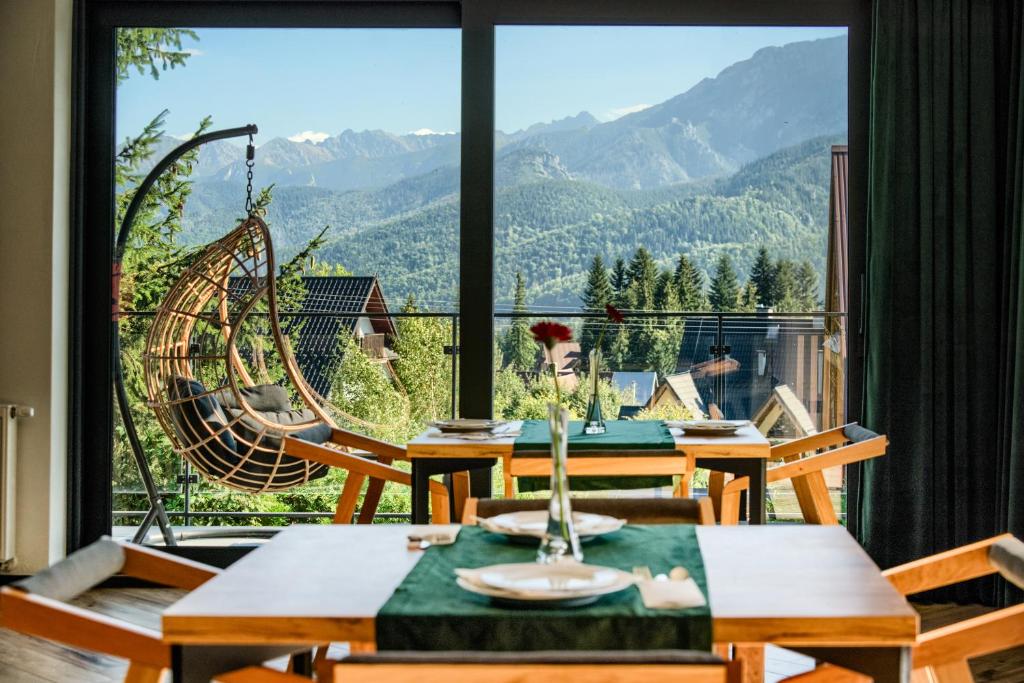 a dining room with a view of the mountains at Widokowa Villa TOP - ADULTS ONLY in Kościelisko