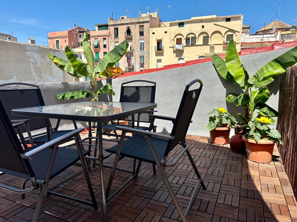 a table and chairs on a patio with plants at Little Horse apartments 3 in Tarragona