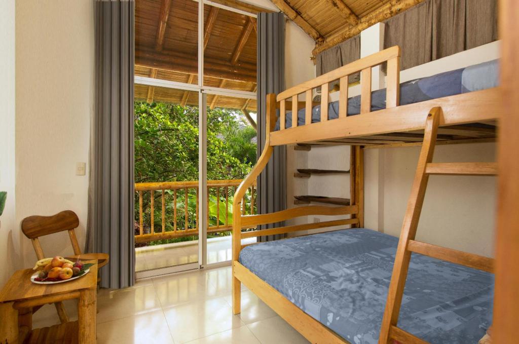 Postel nebo postele na pokoji v ubytování ITCHIMBIA GARDEN AYAMPE Montaña y Mar