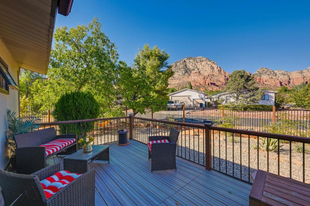 a deck with chairs and tables with a view of mountains at Peaceful Sedona Home - Walk to Amitabha Stupa! in Sedona