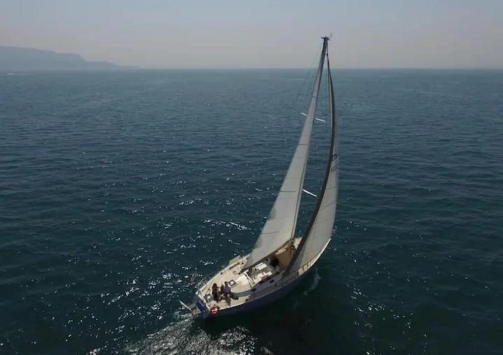 a sail boat in the ocean on the water at Barca a Vela Principessa in Porto Carollo