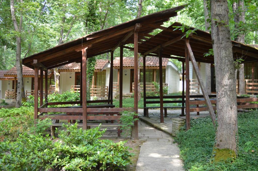 a wooden pavilion in the middle of a forest at Villas Ropotamo in Primorsko
