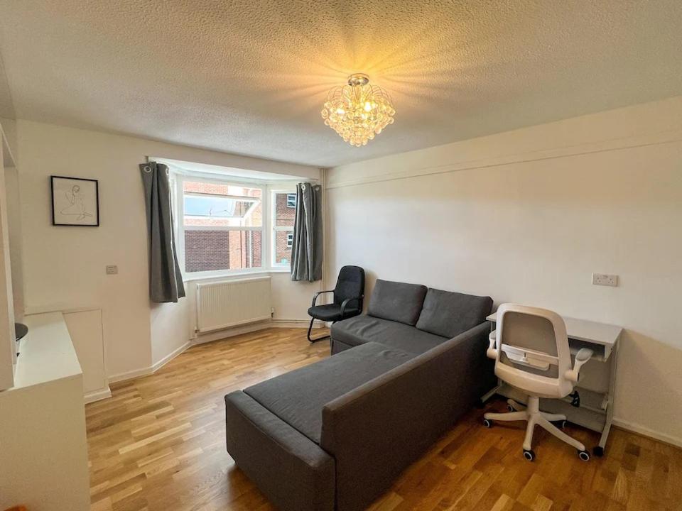 a living room with a couch and a chair at Stylish apartment in city centre in Oxford
