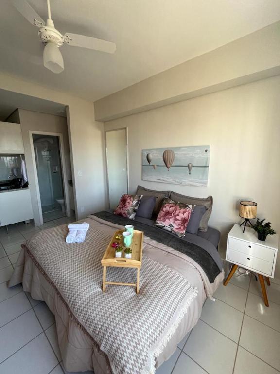 a bedroom with a large bed with a table on it at Travellar Spot 1225A in Ribeirão Preto