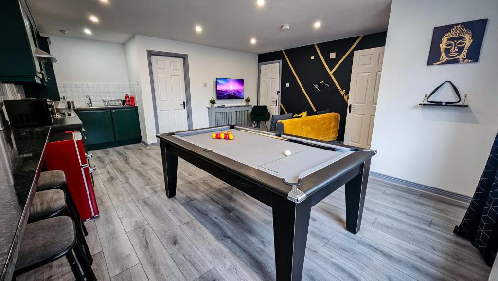 a room with a ping pong table in the middle of it at Modern City Centre Apartment in Belfast