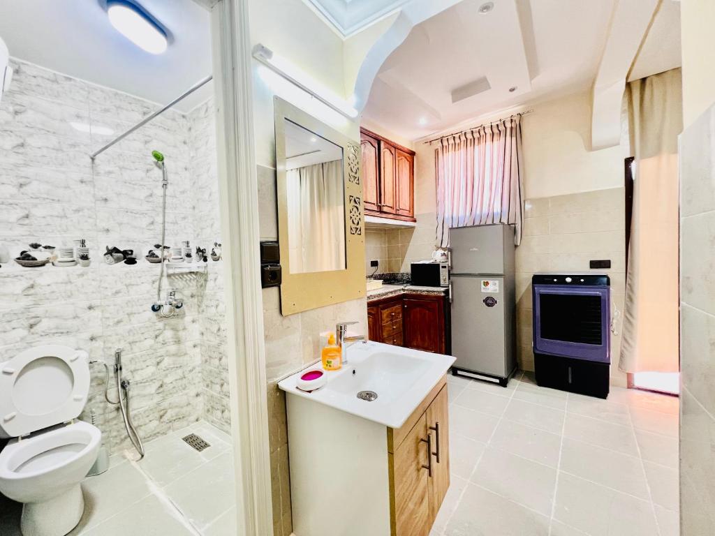 a bathroom with a toilet and a sink and a shower at Famille Hanae appartement avec terasse in Marrakesh