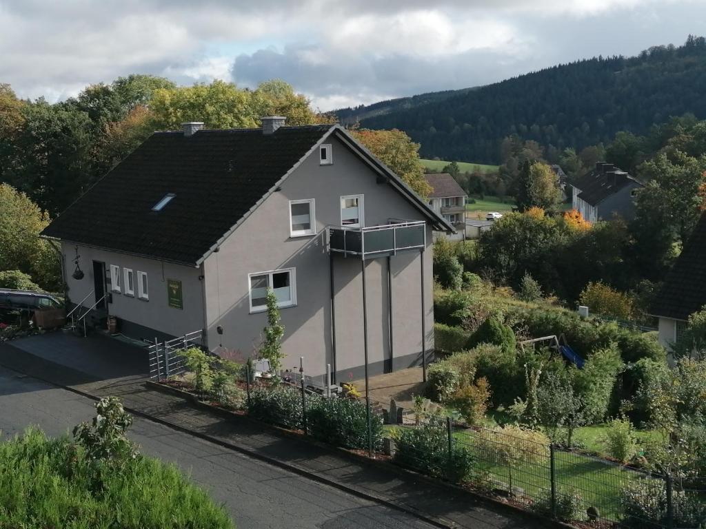 a white house with a black roof at Waldglück Familie Brüning in Bad Berleburg