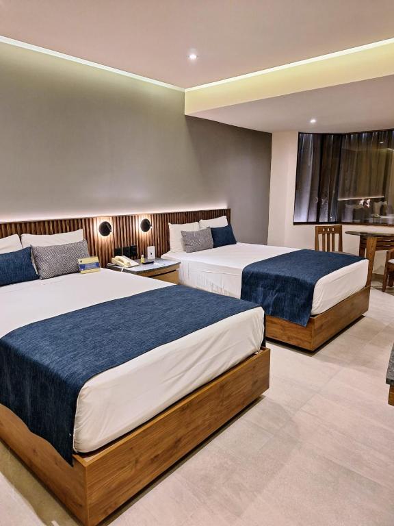 Postel nebo postele na pokoji v ubytování Hotel Guadalajara Plaza Ejecutivo