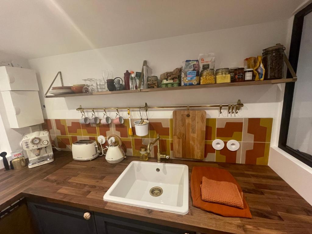 a kitchen with a sink and a counter top at Studio Calme Batignolles in Paris