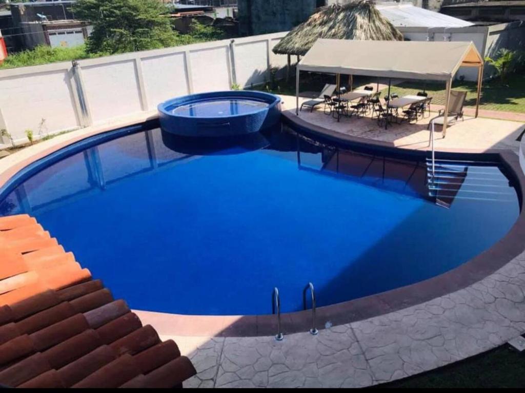 a large blue swimming pool with a table and chairs at HOTEL MILIN 