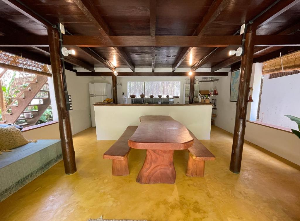 a wooden table in the middle of a room at OLITAS - Praia de algodões in Marau
