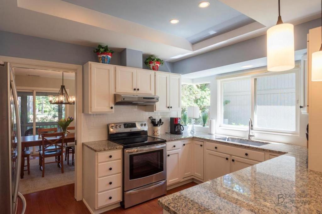 a kitchen with white cabinets and a stove top oven at 12 Isle of Pines in Hilton Head Island