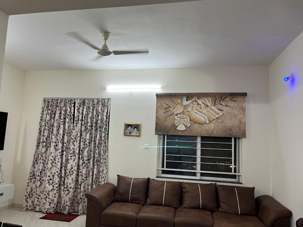 a living room with a couch and a window at Little nest Homestay in Pune