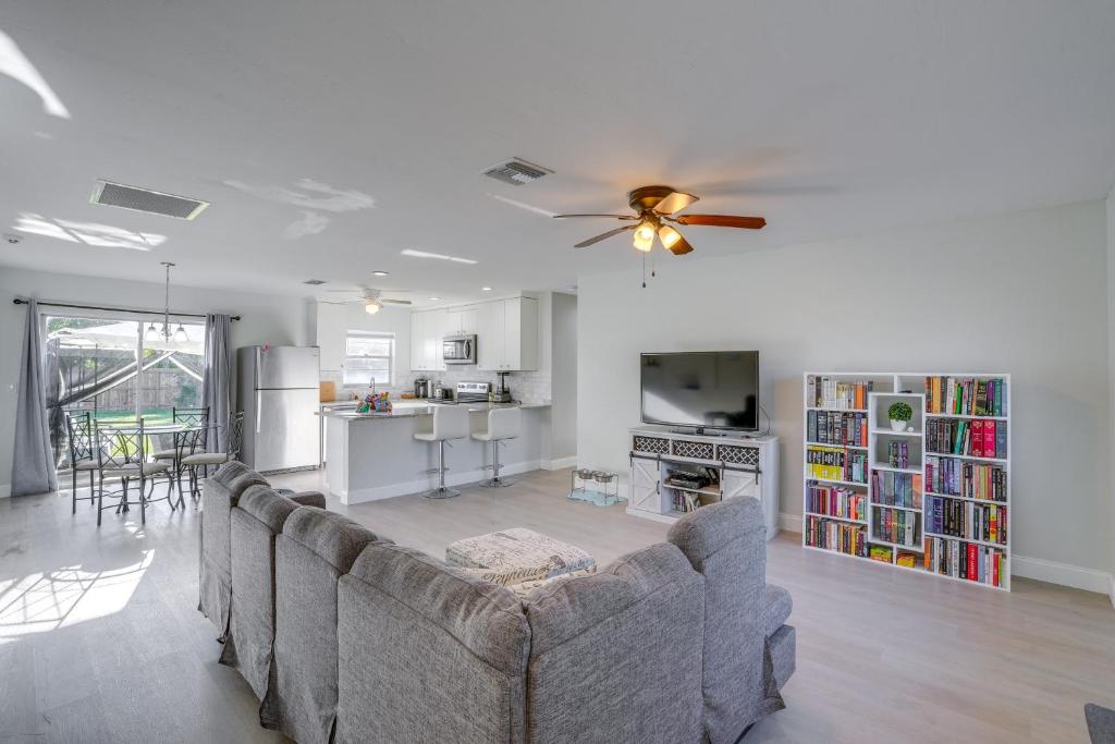 a living room with a couch and a ceiling fan at Fort Myers Vacation Home with Patio about 14 Mi to Beach in Fort Myers