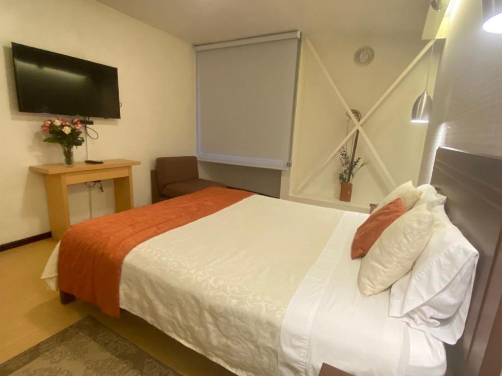 Postel nebo postele na pokoji v ubytování Suites Metropoli