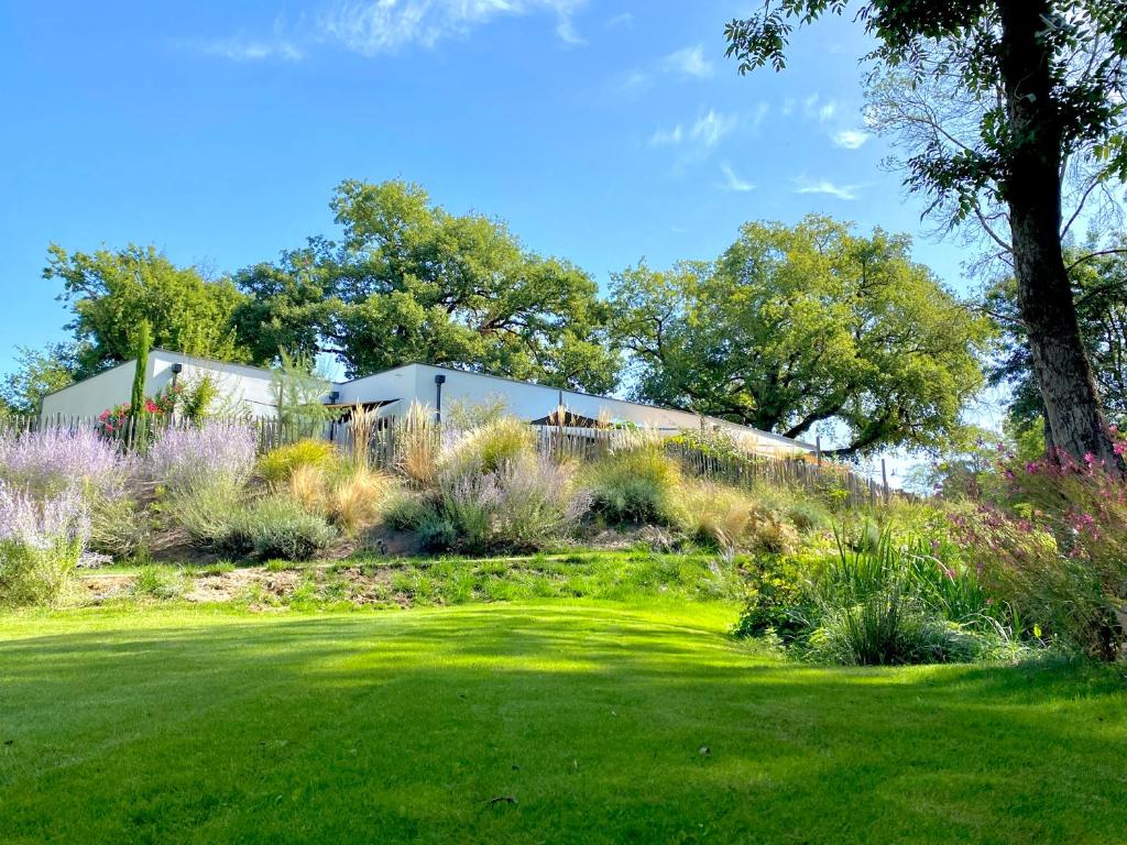 a house on a hill with a green yard at Chambres avec Jacuzzi privatif - Kassiopée Bed & Spa in Albi