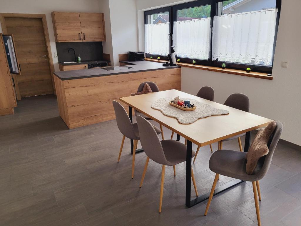 a kitchen with a table and chairs in a room at Bergblick Wohnung Posch in Imst