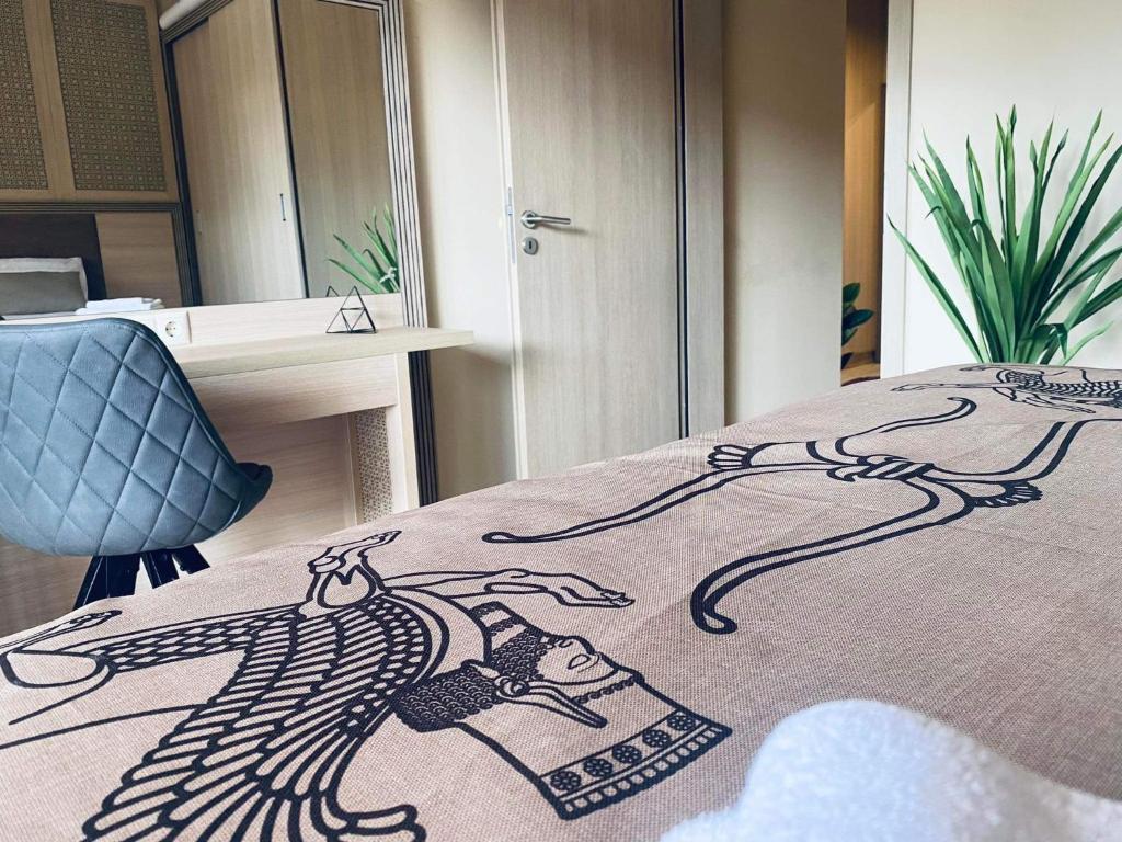 a bed with a drawing of a woman on it at Argisht Luxury Apartment Golden Sands in Golden Sands