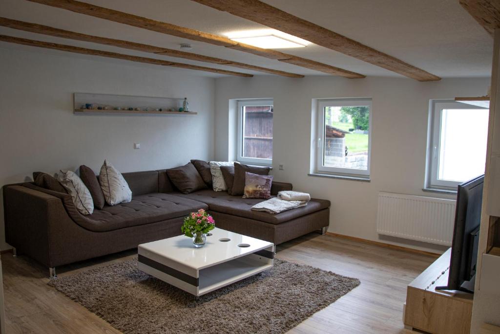 a living room with a couch and a coffee table at Ferienwohnung Bauernhaus in Balingen