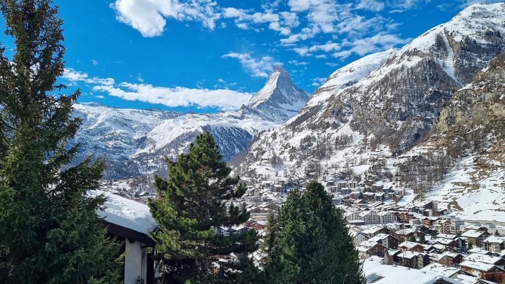 a town in the mountains with a snow covered mountain at Chalet Michelangelo in Zermatt