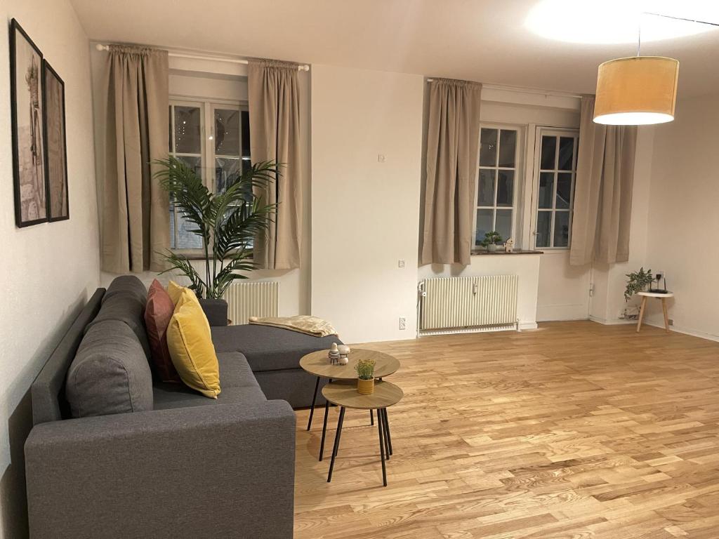 a living room with a couch and a table at aday - Large terrace and 2 bedrooms apartment in the heart of Randers in Randers