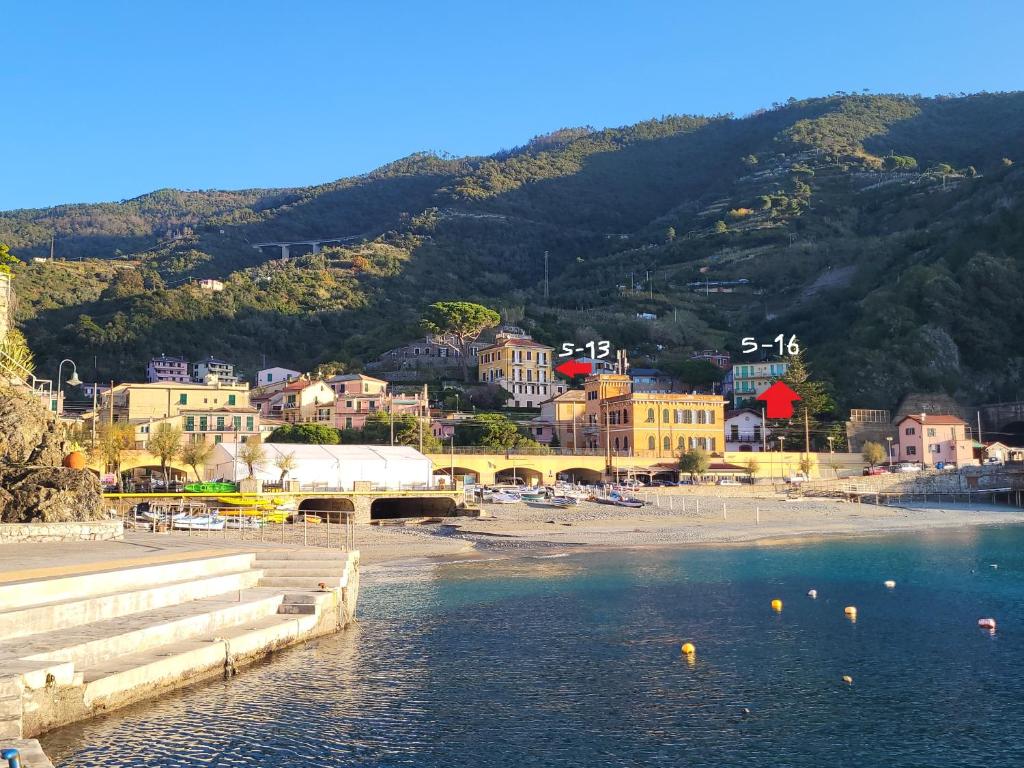 a view of a beach with a town and mountains at Monterosso Servano's Villas in Monterosso al Mare