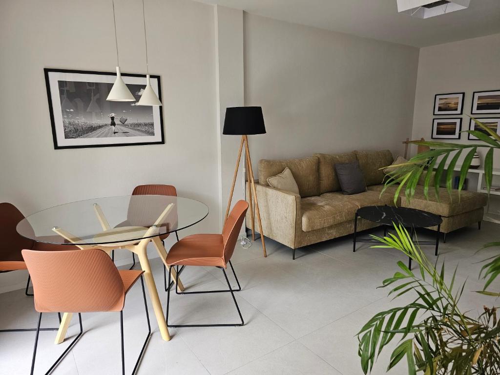 a living room with a table and a couch at Casa Pajo - Moderna, personal y con bicicletas in San Pedro del Pinatar