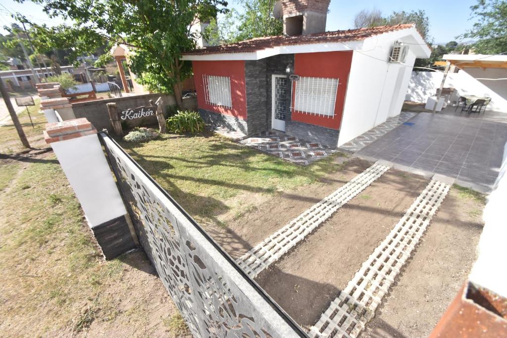 a house with a fence in front of it at Kaiken Maison in Villa Santa Cruz del Lago