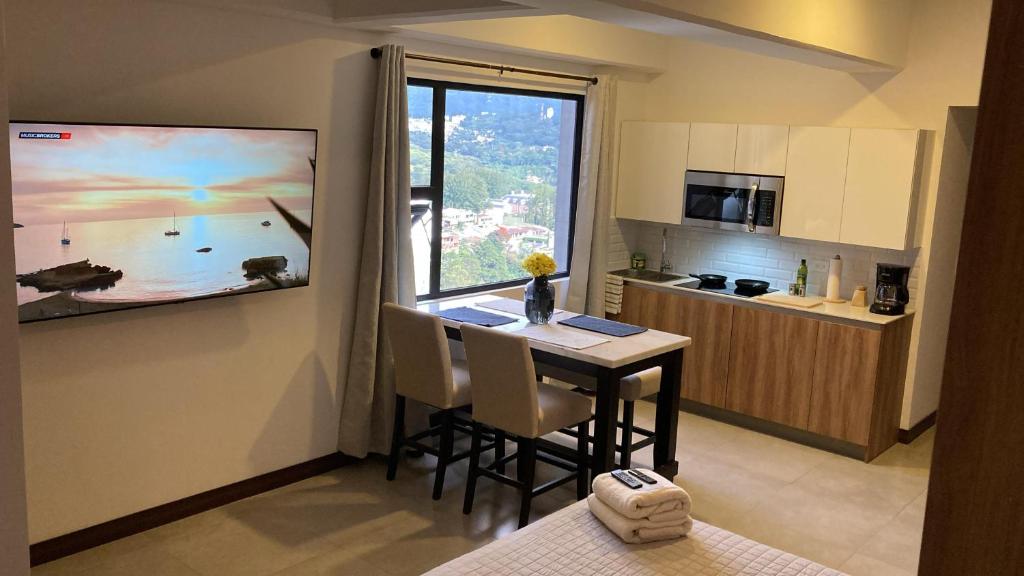 a kitchen with a table and a window in a room at Unique Studio Apartment in the heart of Guatemala City in Guatemala