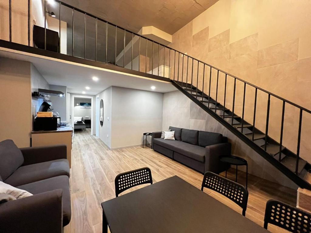 a living room with a couch and a staircase at VLC Apart in Valencia