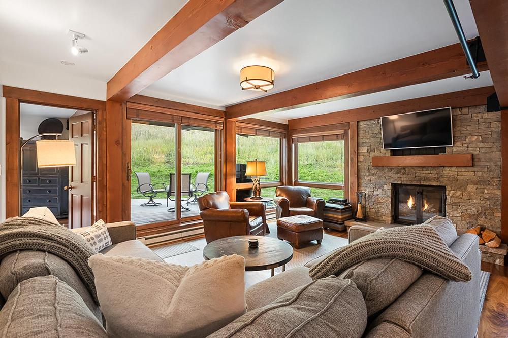 a living room with a couch and a fireplace at Enclave 108, Snowmass Ski-In Ski-Out Condo with Shared Pool, Hot Tub & Gym in Snowmass Village