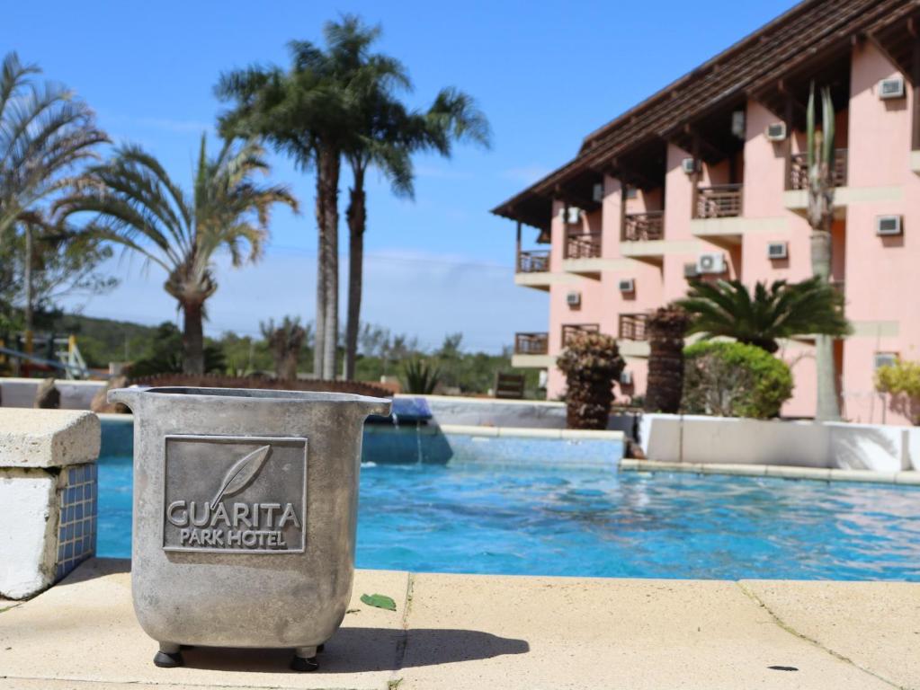a trash can in front of a swimming pool at Guarita Park Hotel - By Life Hotéis in Torres