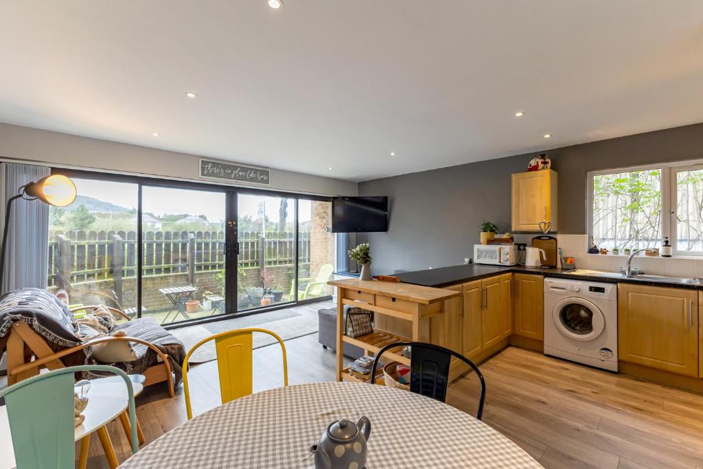 a kitchen and living room with a table and chairs at Central Apartment 3B in Newcastle