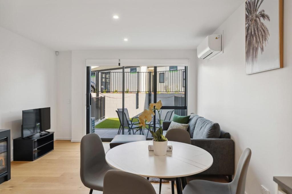 a living room with a table and a couch at Rivers Edge - Alberttown in Albert Town